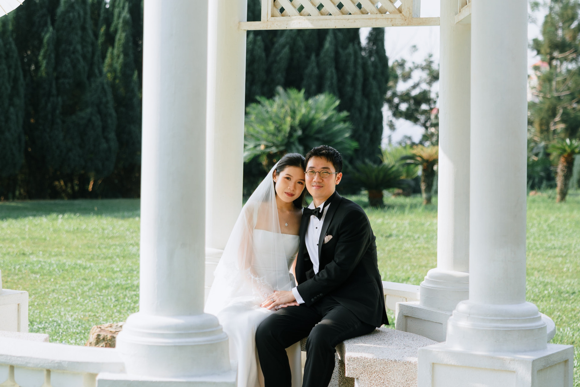Wui Yan and Li Yen seated together in a garden pavilion